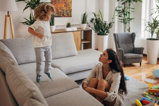 Little boy and mom playing in living room